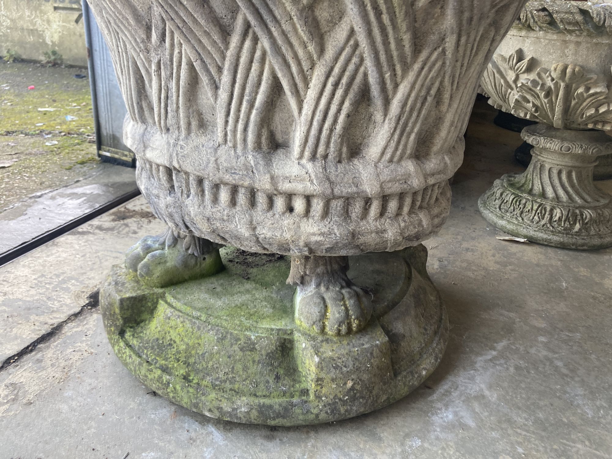 A large Lucas reconstituted stone garden planter on lions paw plinth foot, diameter 74cm, height 60cm